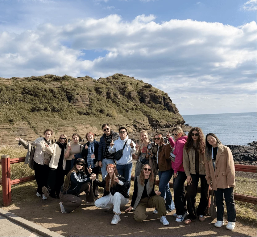 A group of travelers by a sea cliff