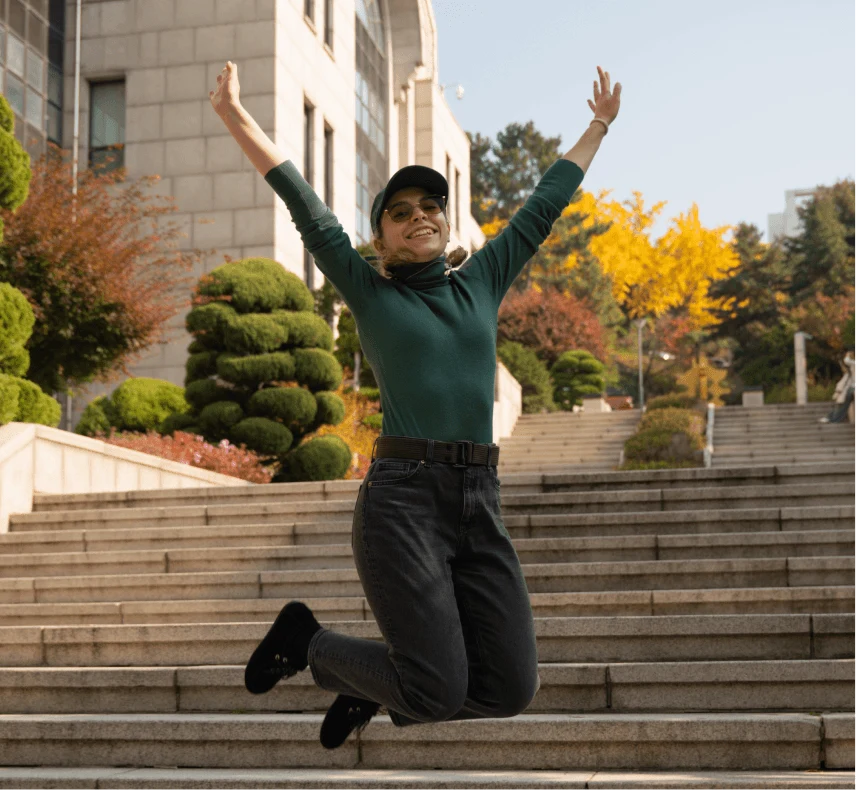 Tourist jumping on steps