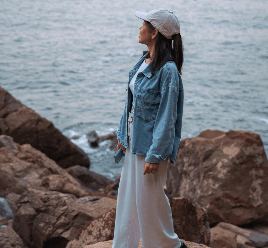 A tourist on a rocky seashore