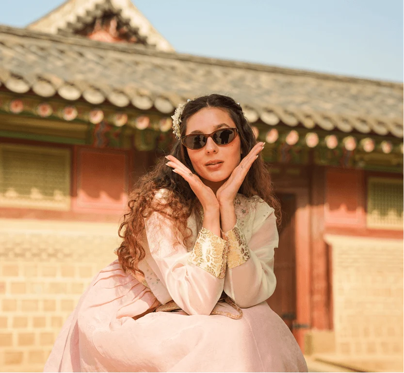 A traveler in a light hanbok by the palace